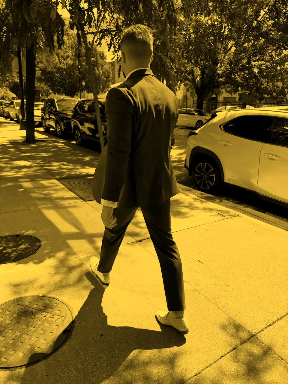 Caiden Sloan in a burgundy suit walking a Chicago street